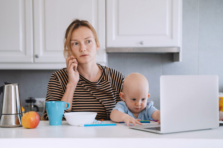 Mother balancing between work and baby on sick or maternity leave